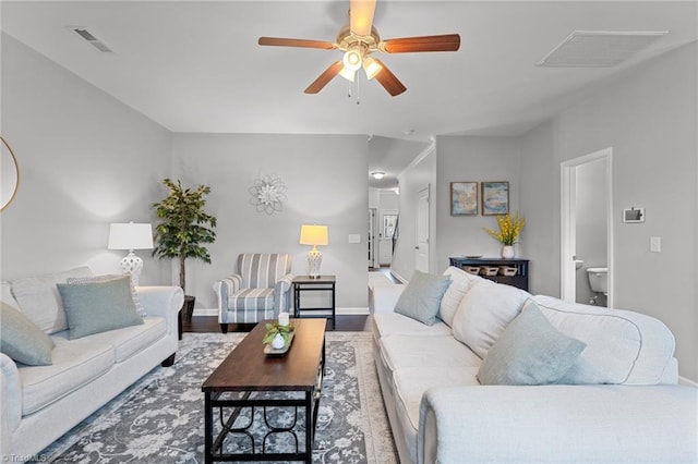 living room featuring wood-type flooring and ceiling fan