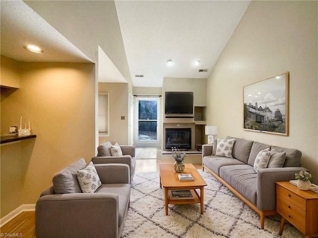 living room featuring light hardwood / wood-style floors and vaulted ceiling