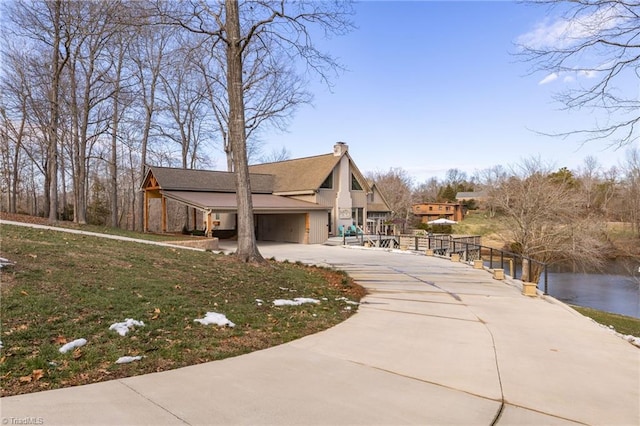 exterior space with a garage and a water view