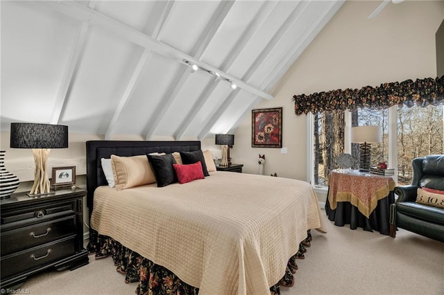 carpeted bedroom with lofted ceiling with beams and rail lighting