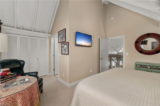 carpeted bedroom featuring a closet and vaulted ceiling