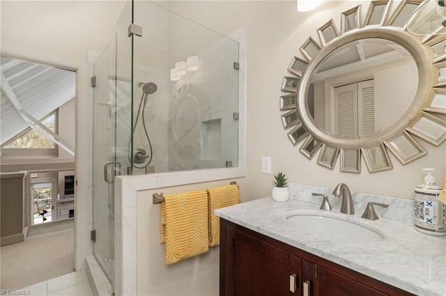 bathroom featuring tile patterned flooring, walk in shower, and vanity