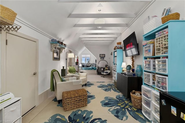 sitting room featuring lofted ceiling with beams and carpet flooring