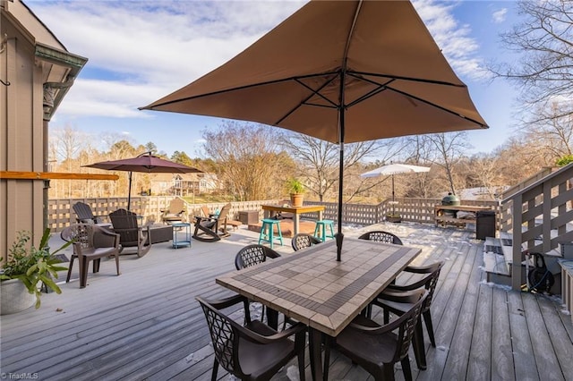 wooden terrace featuring an outdoor fire pit