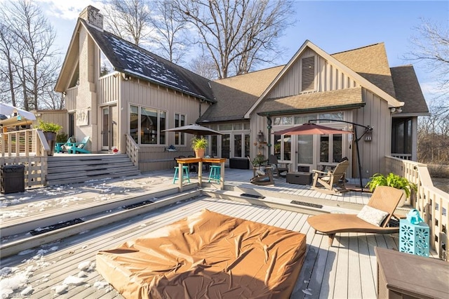 back of house featuring a deck and french doors