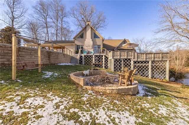 yard layered in snow featuring a deck