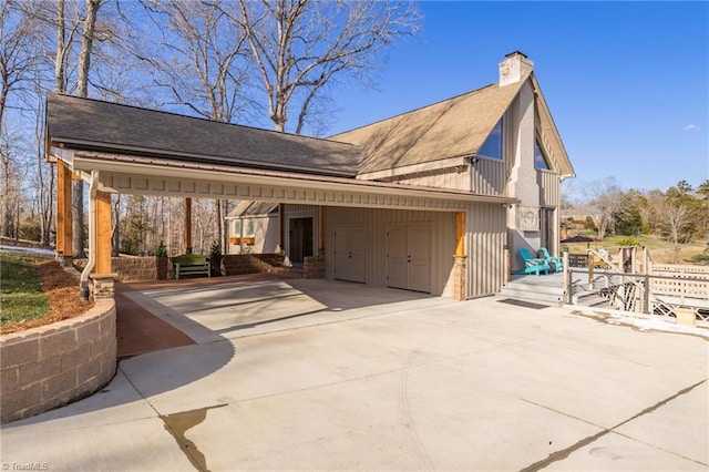 view of home's exterior featuring covered porch and a garage