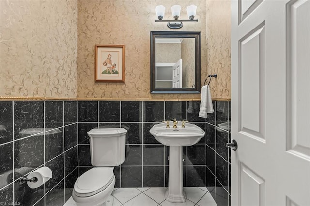 8040 Crosscreek Trl, Pfafftown, NC 27040 - half bathroom featuring a wainscoted wall, tile walls, wallpapered walls, and tile patterned floors