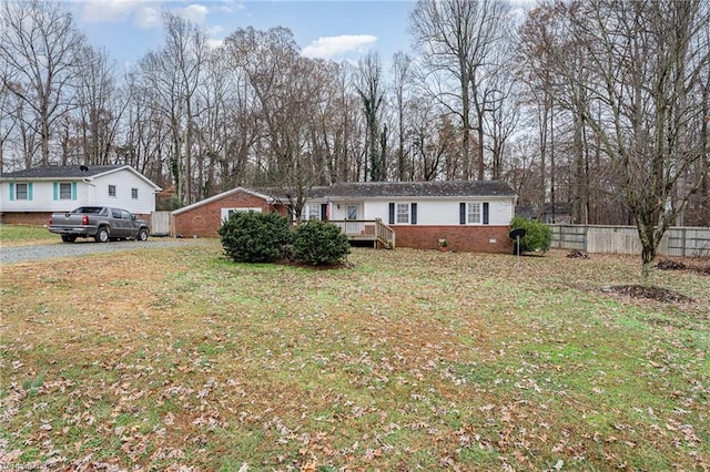 view of front of property with a front lawn and a wooden deck