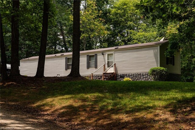 4933 W NC Highway 268, Wilkesboro, NC 28697 - view of front of home with entry steps, a front yard, and view of scattered trees