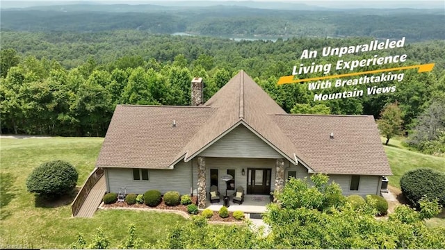 4933 W NC Highway 268, Wilkesboro, NC 28697 - view of front of home with a forest view, a chimney, a front lawn, and stone siding