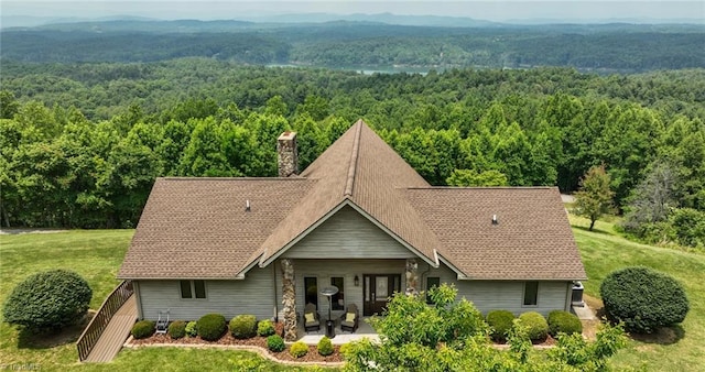 4933 W NC Highway 268, Wilkesboro, NC 28697 - view of front facade featuring a forest view, a chimney, a patio, a front yard, and a shingled roof