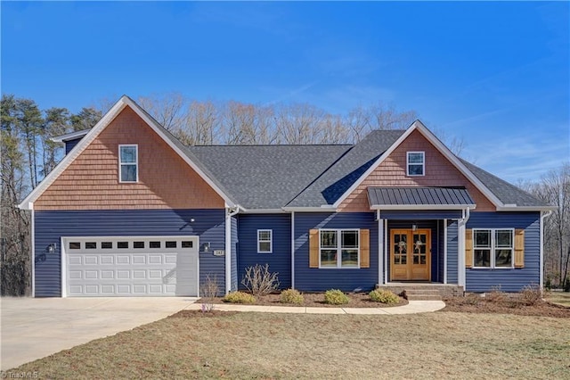 view of front of home featuring a garage and a front yard