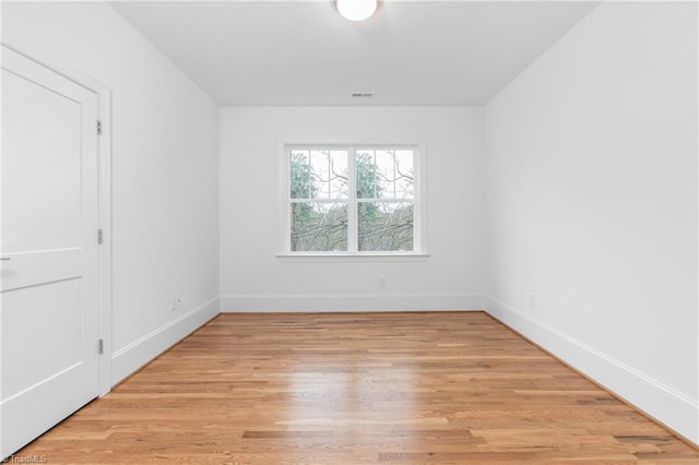 unfurnished room featuring visible vents, baseboards, and light wood-style floors