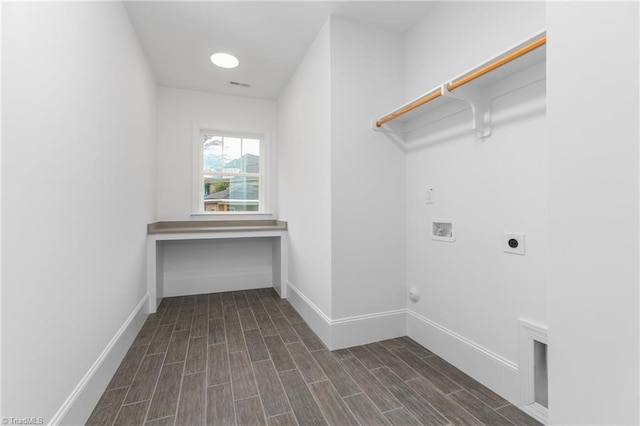 laundry area with baseboards, hookup for an electric dryer, wood tiled floor, laundry area, and washer hookup