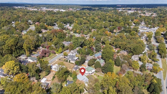 birds eye view of property with a wooded view