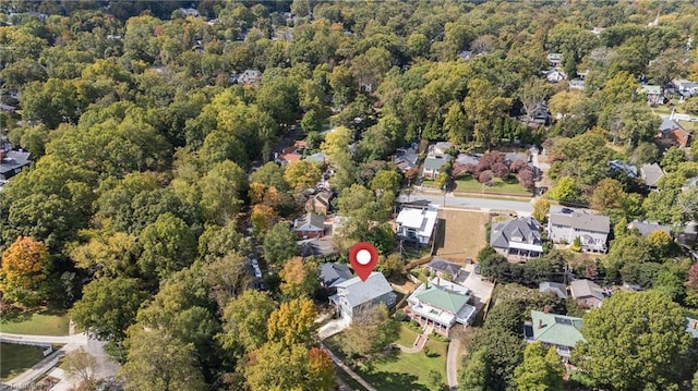 birds eye view of property featuring a forest view and a residential view