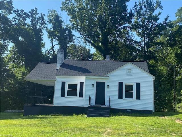 630 Liberty Rd, High Point, NC 27263 - view of front of home featuring a front yard, a chimney, and roof with shingles