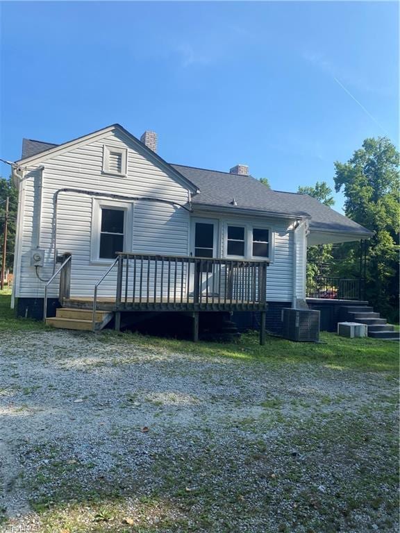 630 Liberty Rd, High Point, NC 27263 - back of property with a chimney, a deck, and a shingled roof