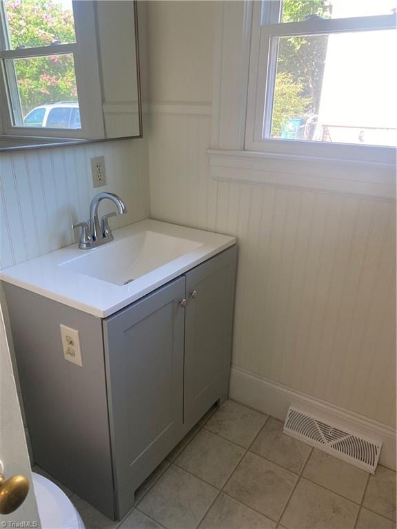 630 Liberty Rd, High Point, NC 27263 - bathroom featuring vanity, tile patterned flooring, and wainscoting