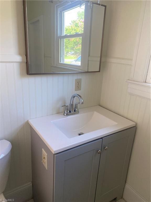 630 Liberty Rd, High Point, NC 27263 - half bathroom featuring vanity, a decorative wall, and a wainscoted wall