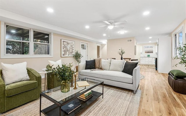 living room featuring light wood-type flooring and ceiling fan