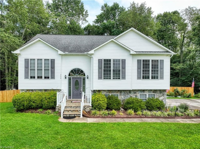 raised ranch with a front yard