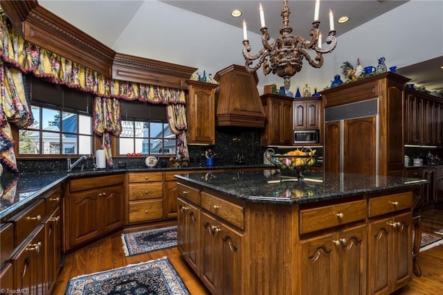 6 Curtis Ct, Thomasville, NC 27360 - kitchen with built in appliances, a chandelier, premium range hood, wood finished floors, and a kitchen island