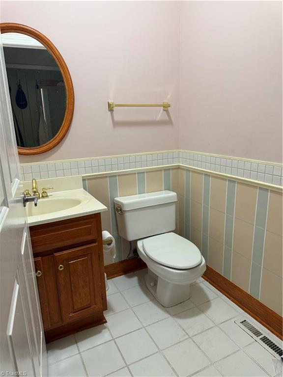 1223 Gatehouse Rd, High Point, NC 27262 - half bath with toilet, vanity, and tile patterned flooring