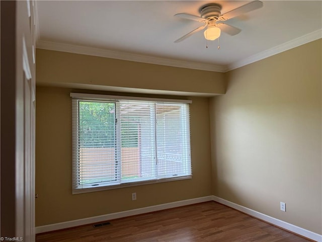 1223 Gatehouse Rd, High Point, NC 27262 - spare room with healthy amount of natural light, ornamental molding, wood finished floors, and ceiling fan
