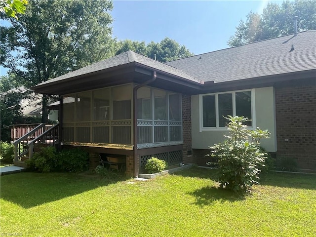 1223 Gatehouse Rd, High Point, NC 27262 - back of property with roof with shingles, brick siding, a lawn, and a sunroom