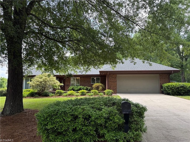 1223 Gatehouse Rd, High Point, NC 27262 - ranch-style house with an attached garage, concrete driveway, and brick siding