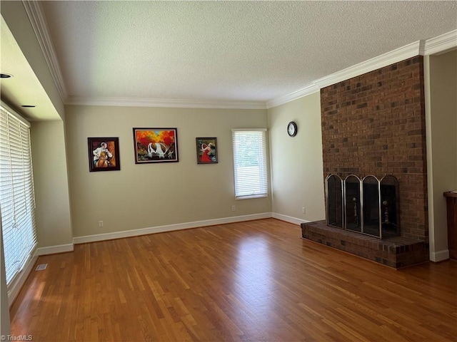 1223 Gatehouse Rd, High Point, NC 27262 - unfurnished living room with a textured ceiling, wood finished floors, crown molding, a fireplace, and baseboards