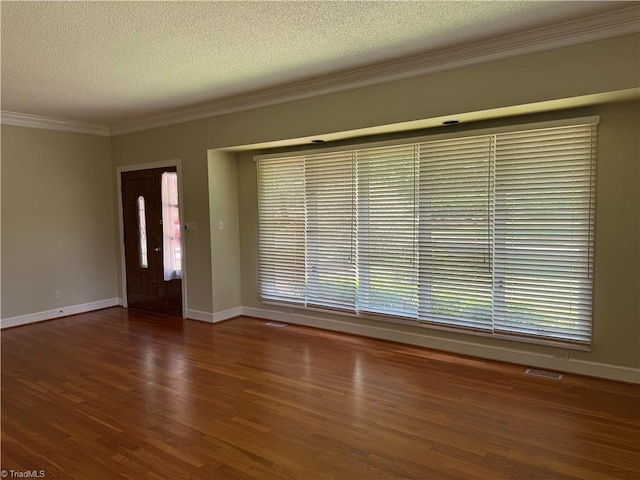 1223 Gatehouse Rd, High Point, NC 27262 - unfurnished living room featuring ornamental molding, wood finished floors, baseboards, and a textured ceiling