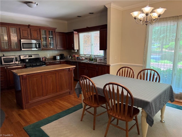 1223 Gatehouse Rd, High Point, NC 27262 - kitchen featuring appliances with stainless steel finishes, a center island, a chandelier, wood finished floors, and a sink