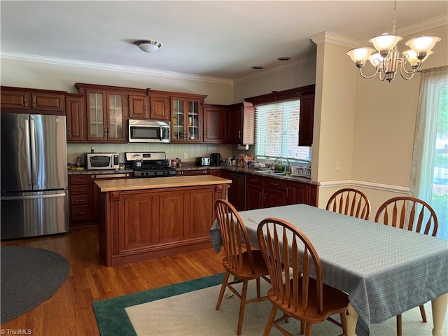 1223 Gatehouse Rd, High Point, NC 27262 - kitchen featuring appliances with stainless steel finishes, a sink, a chandelier, a kitchen island, and wood finished floors