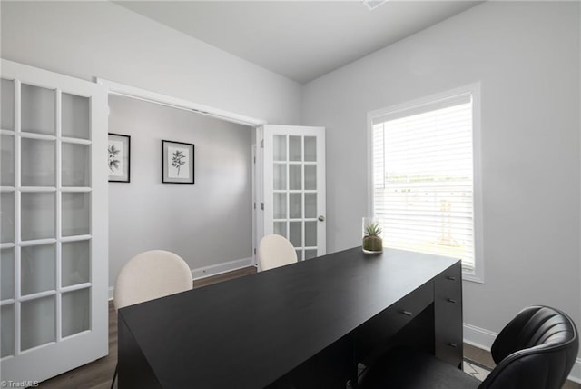 home office with dark hardwood / wood-style flooring and french doors