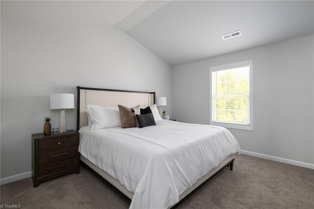 bedroom with carpet and lofted ceiling