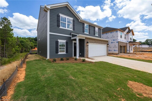 view of front of property featuring a garage and a front yard