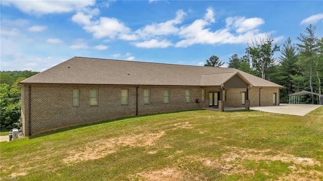 back of property featuring a yard and a patio area