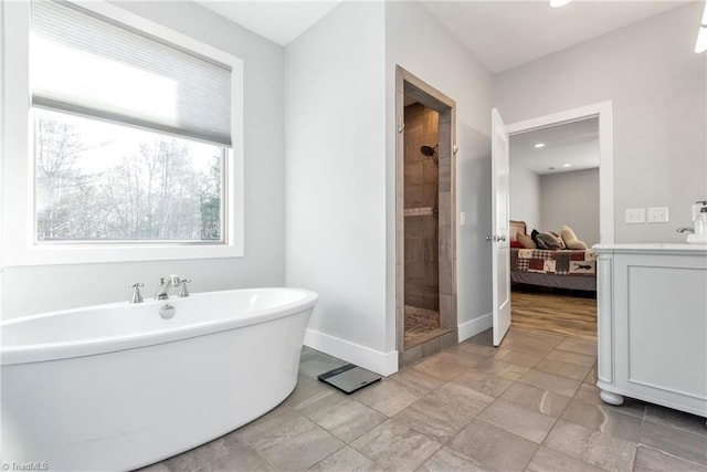 bathroom featuring vanity and shower with separate bathtub