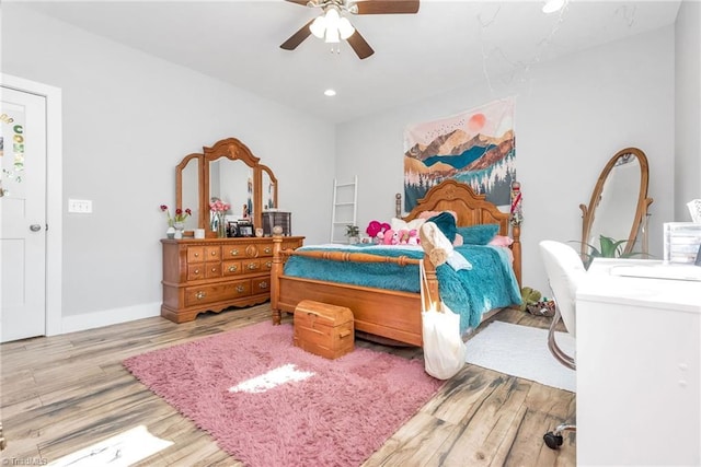 bedroom with ceiling fan and light hardwood / wood-style flooring