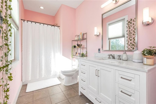 bathroom featuring tile patterned floors, vanity, and toilet