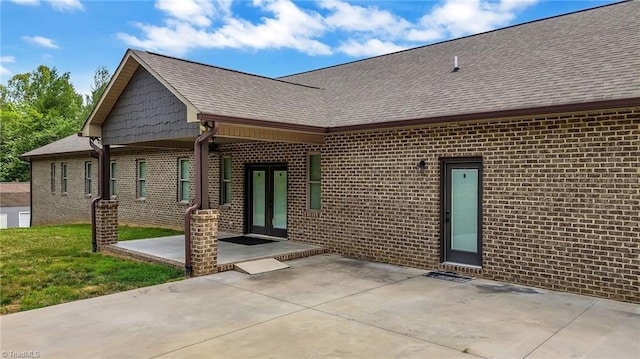 rear view of house with a patio area and french doors