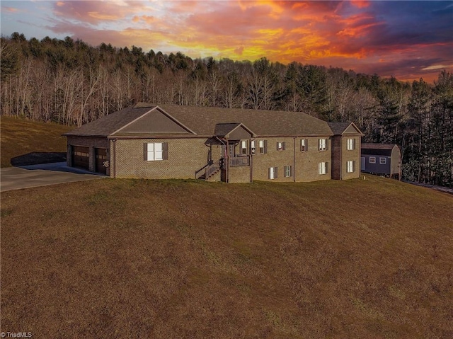 view of front of home featuring a garage and a lawn