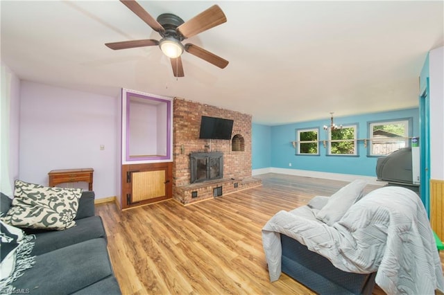 living room with a fireplace, hardwood / wood-style flooring, and ceiling fan