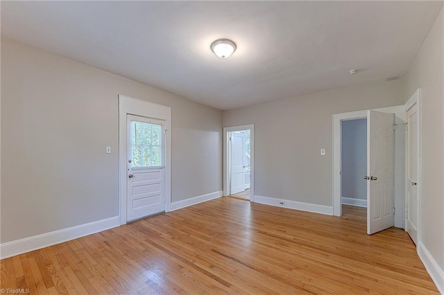 empty room featuring light wood-style floors and baseboards