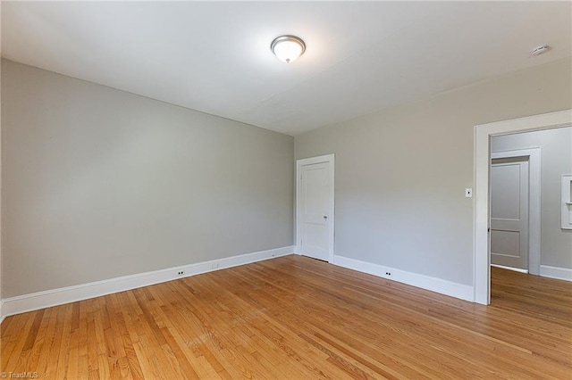 unfurnished room featuring light wood-style flooring and baseboards