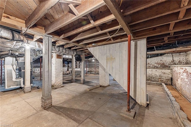 unfinished below grade area with brick wall