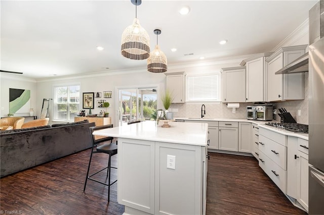 111 Park Place Cir, Winston-Salem, NC 27107 - kitchen featuring open floor plan, a sink, a breakfast bar area, stainless steel gas stovetop, and ornamental molding